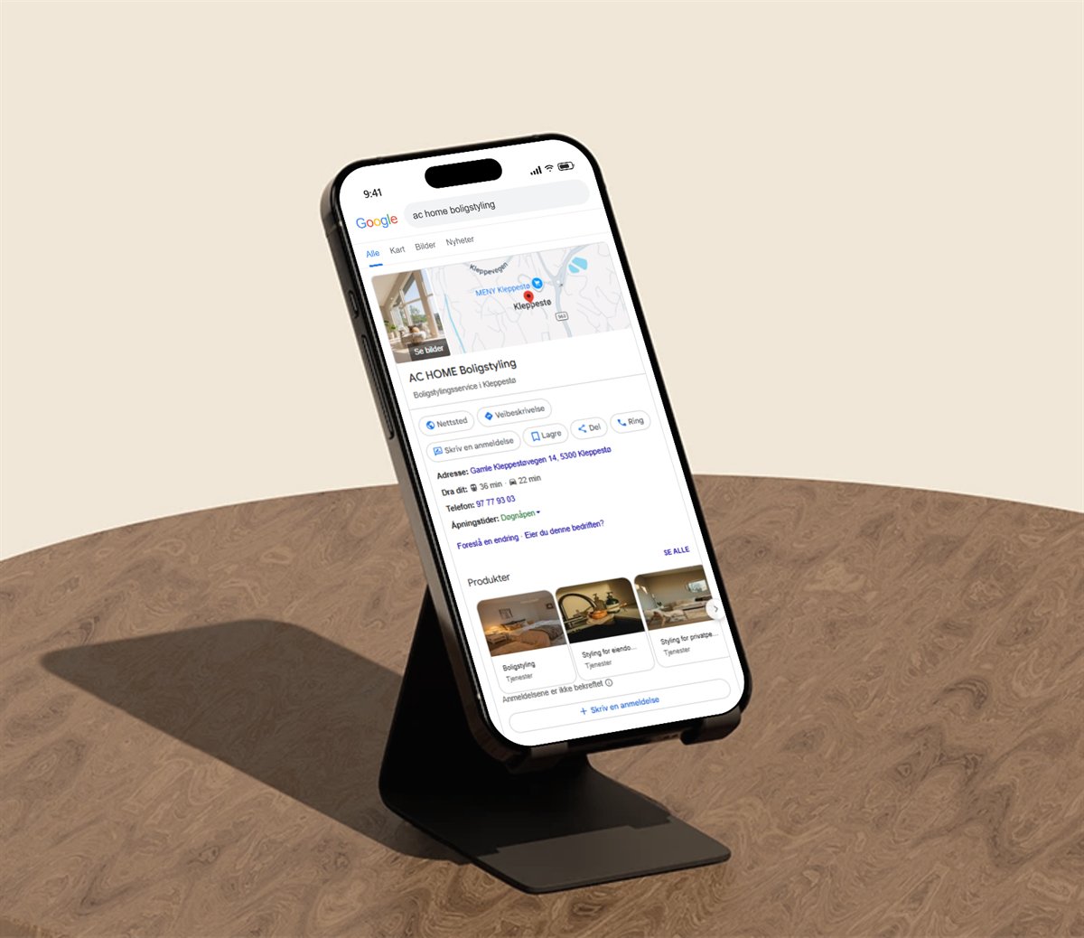 Mobil i stativ som viser Google-bedriftsprofilen til AC Home